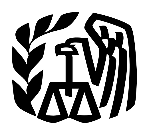 left facing eagle holding a scale with a leaf to the left of the eagle and scale.