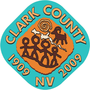 Cave drawing of four people with a goat and the word Clark County 1909 NV 2009